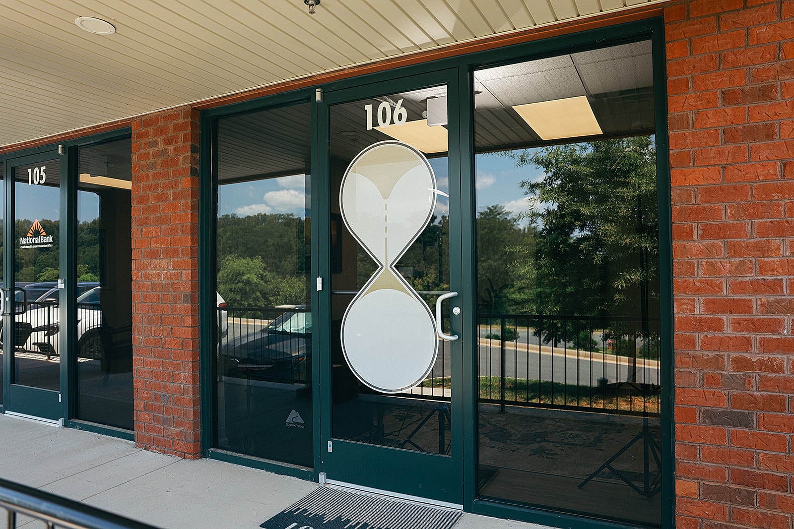 Entrance with hourglass design on glass doors.